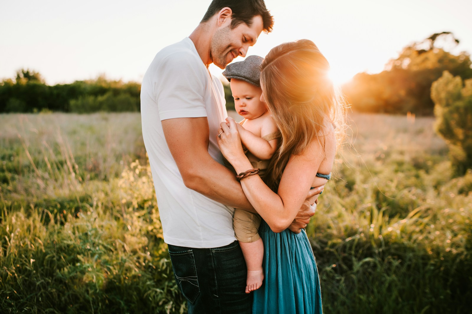 family photo on green grass during golden hour, life